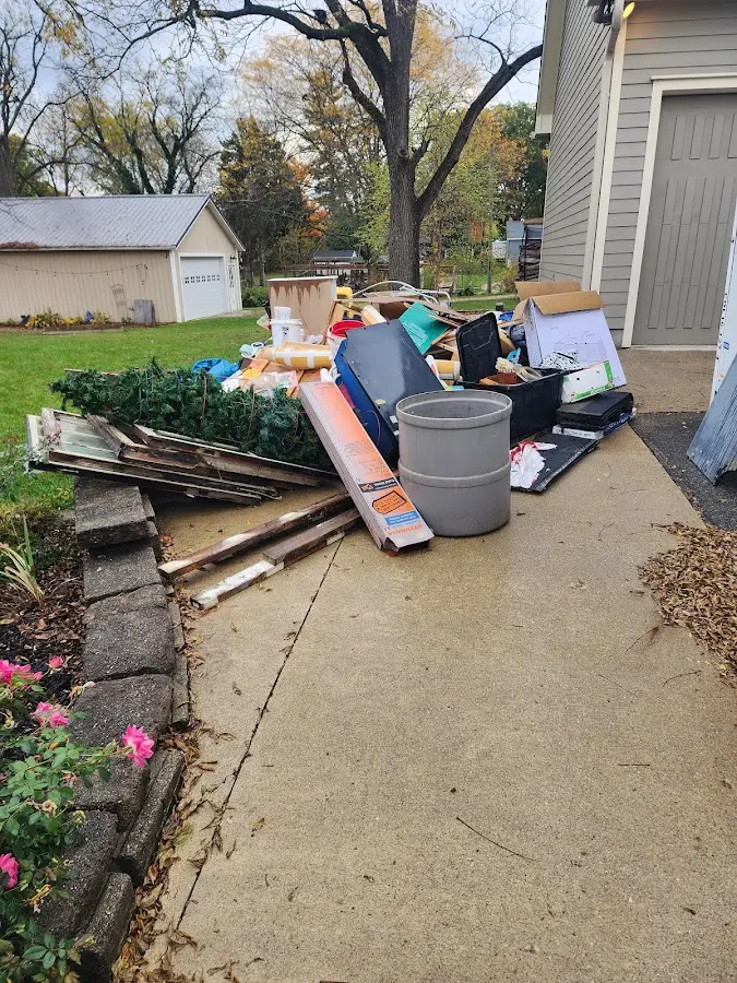 Dumpster being loaded with debris for 30 Yard Dumpster Rental in North Springfield
